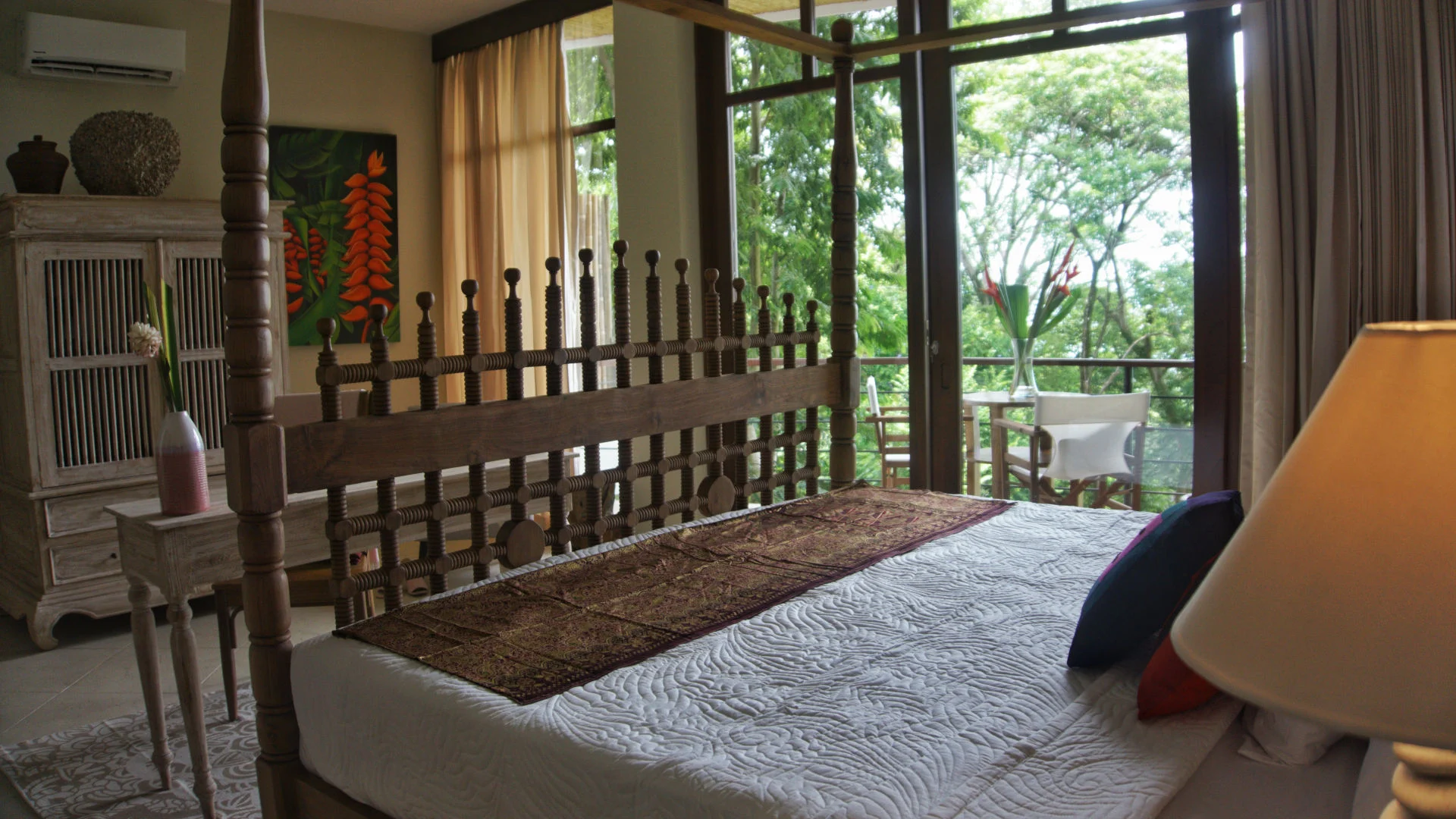 Bedroom with handcrafted wood details and a private terrace overlooking the rainforest in Manuel Antonio