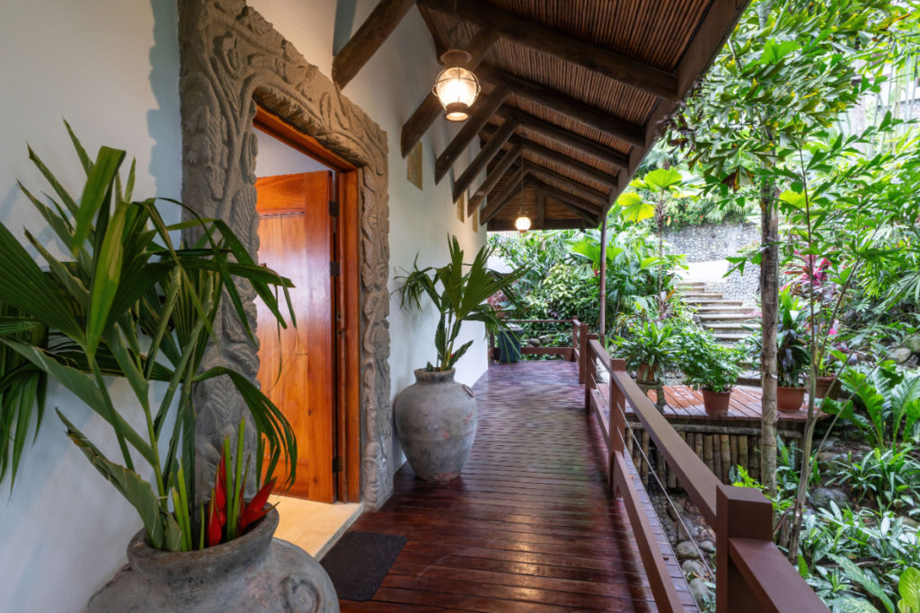The villa is encircled by lush, beautiful gardens.
