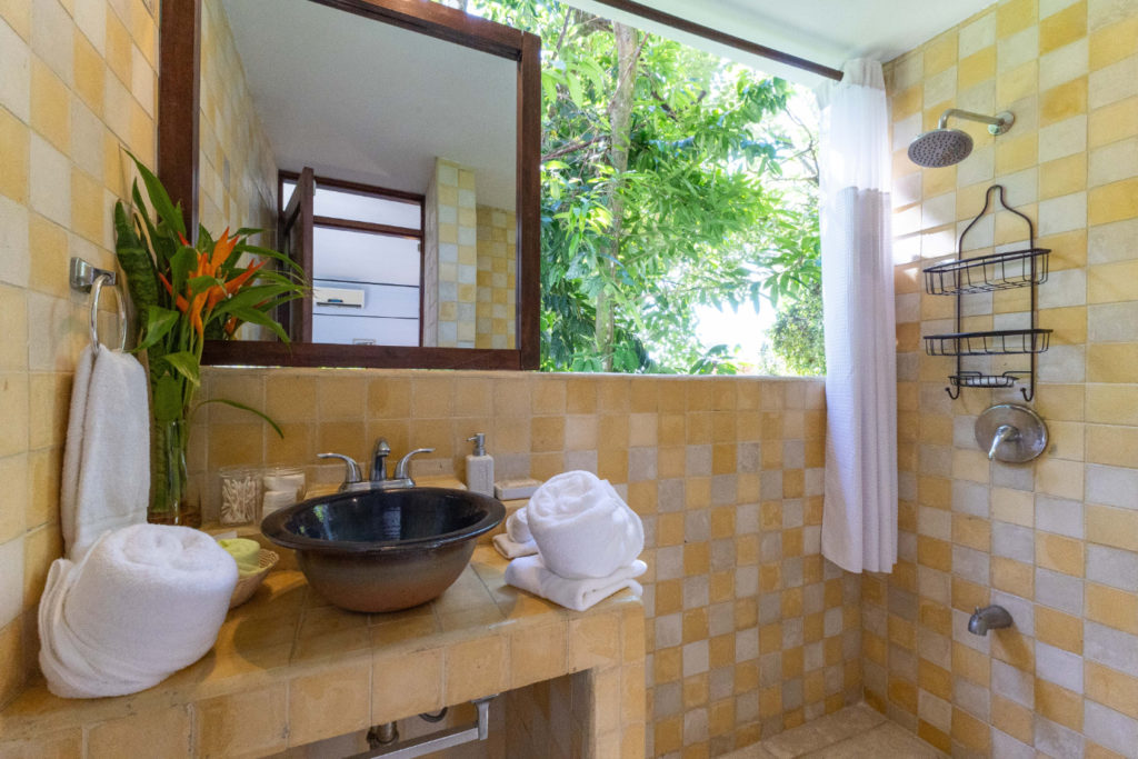 The bathroom's nature-inspired design exudes a soothing and calming ambiance.