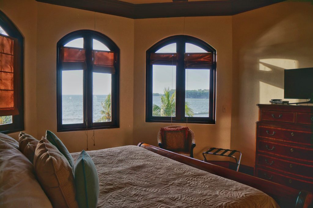 This master bedroom has a king bed, ocean view, and private bath. 