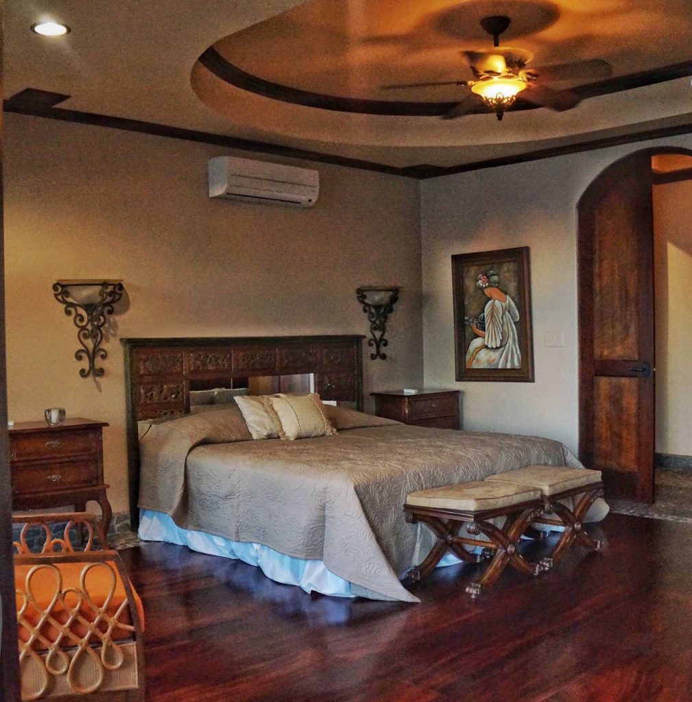 This king bedroom has designer furnishings and artwork throughout. 