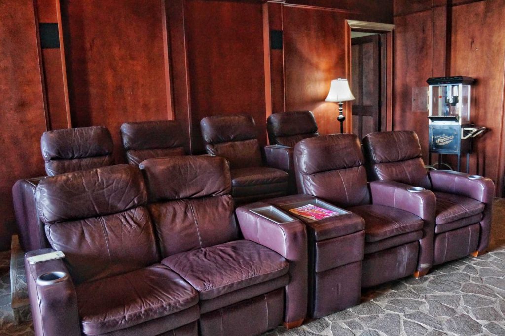 Plush leather recliners in the theater room create a relaxing spot for watching movies. A 63" screen and deluxe sound system complete the experience. 