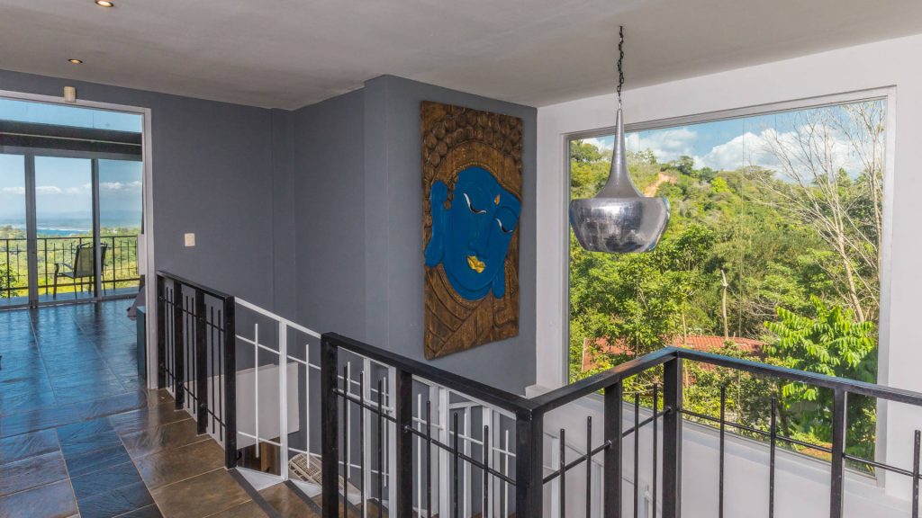 Beautiful artwork adorns the wall on the stairway to the second level with three bedrooms.