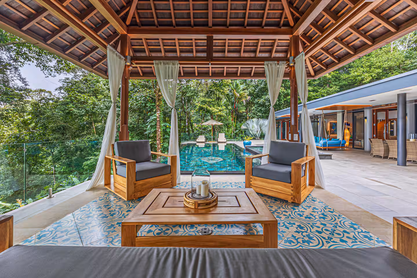 Shaded gazebo lounge with seating beside the pool and jungle surroundings at a luxury villa near Dominical, Costa Rica.