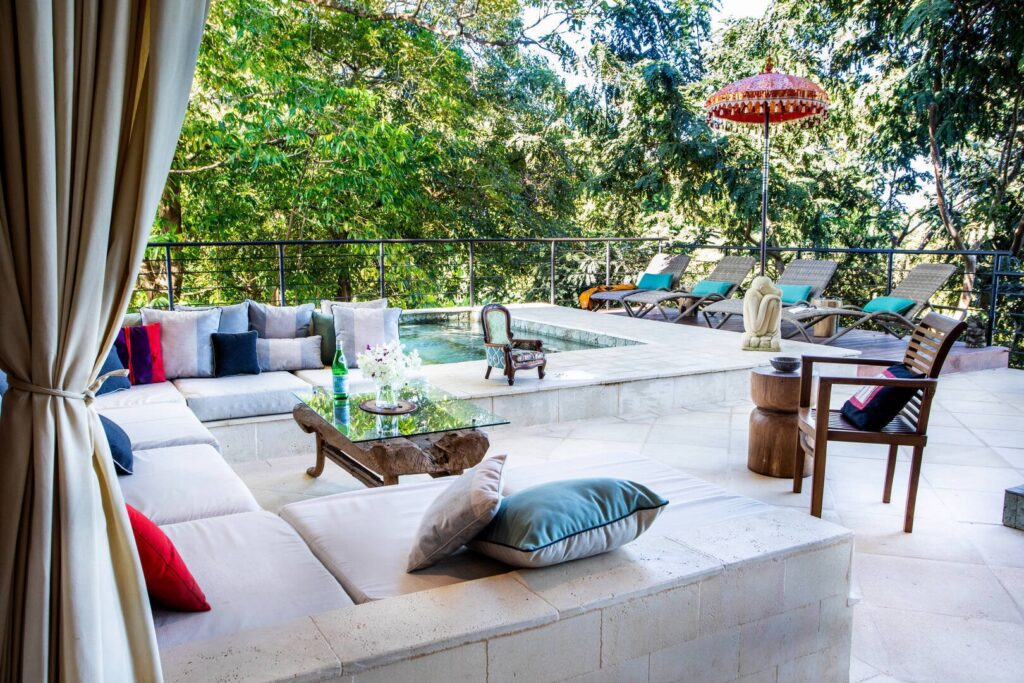 A relaxed jungle-side terrace where a cozy lounge, refreshing plunge pool, and sun loungers invite families to slow down and enjoy the day.