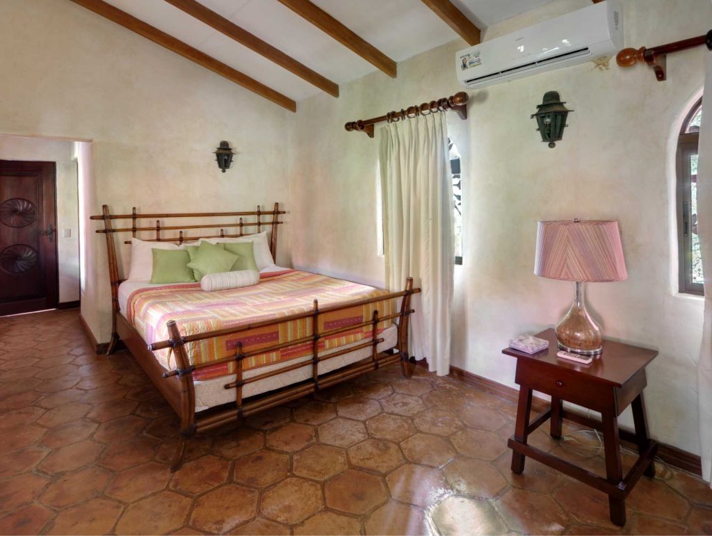 This lovely rattan queen bed is in the second bedroom of the main house. All bedrooms have air conditioning.