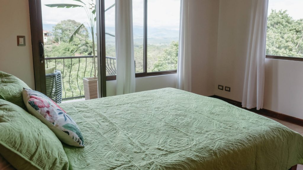The rainforest and mountains of Manuel Antonio are visible from this beautiful upper level queen bedroom.