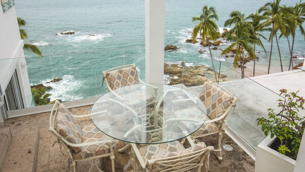 Sit at this round glass table and enjoy a morning coffee, with the perfect views of Puerto Vallarta Mexico. 