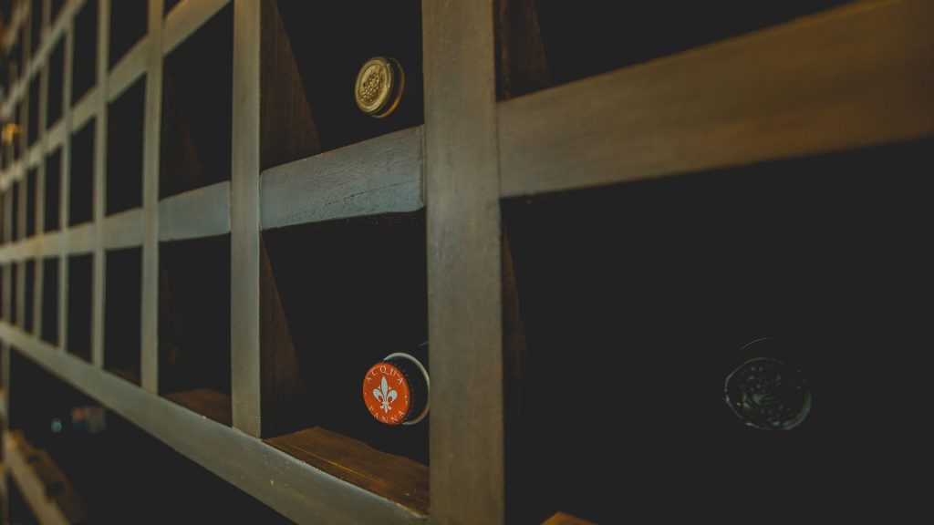 This large custom wood wine rack has a big selection of wines.