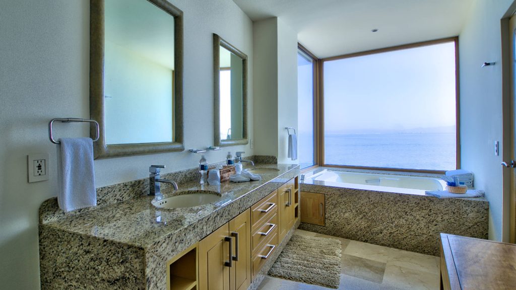 This his and hers bathroom has great views. 