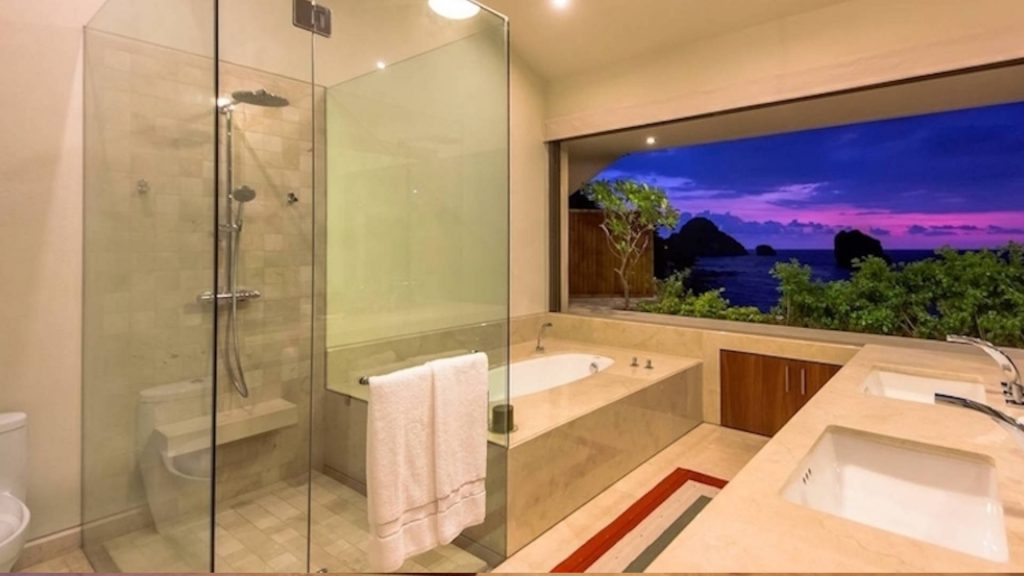 This bathroom has a standup shower with adjustable shower head and deep soaker bath tube and his and hers sinks. You might also enjoy having stunning views just out your large window. 