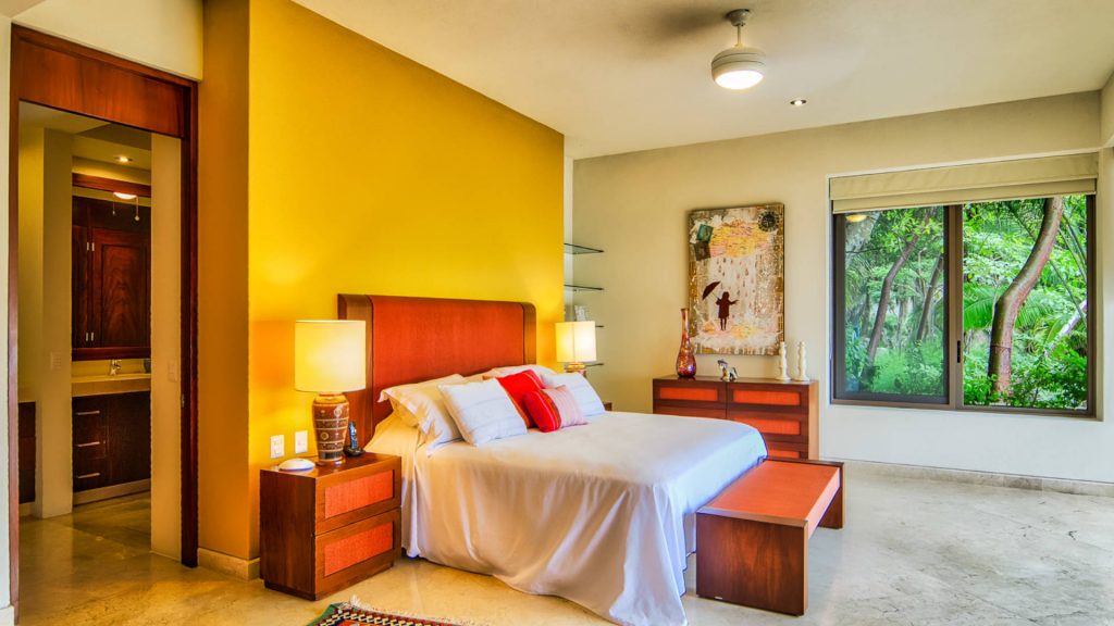 This bedroom is absolutely stunning with bright colors and decor adding to the great views. 