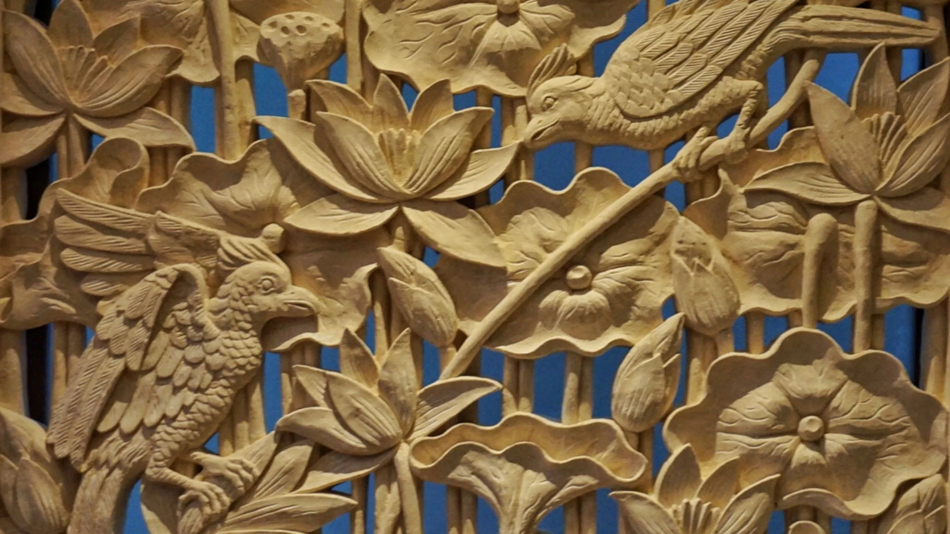 Handcrafted wall art with bird and floral carvings inside a luxury villa in Manuel Antonio
