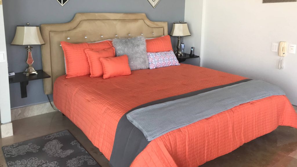 The colorful bedspread really brightens up the room.