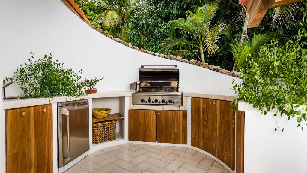 This outdoor barbecue station is great for grilling up your favorite food and comes equipped with a sink and fridge.