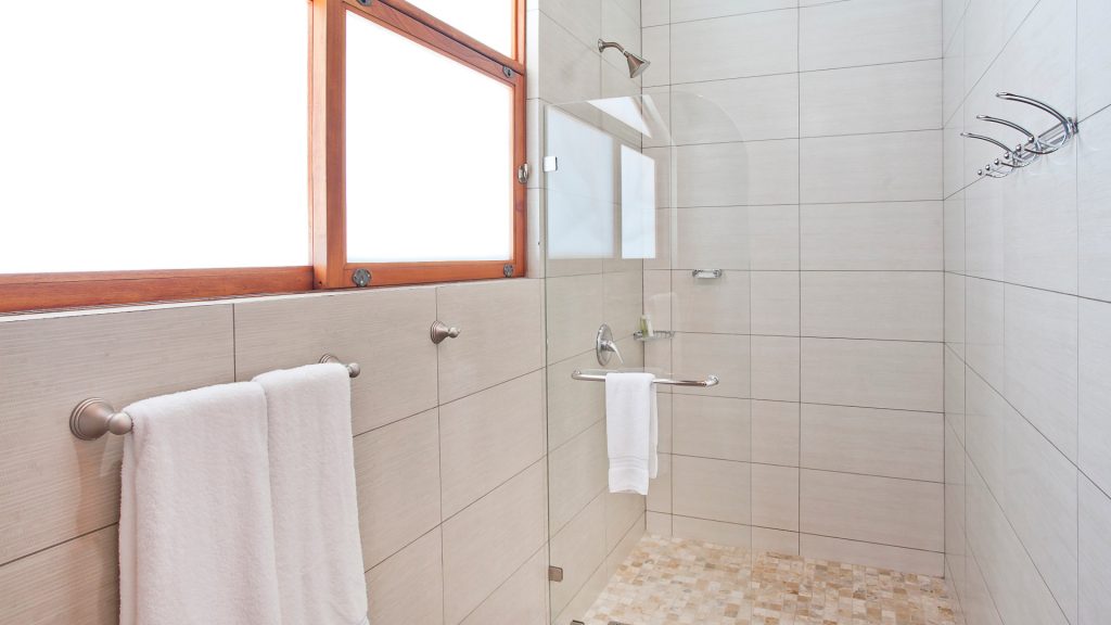 This bathroom has a huge shower with beautiful tile work.