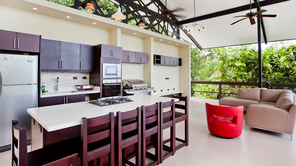 The rooftop open-air kitchen has a BBQ, full size refrigerator, stove, and oven.
