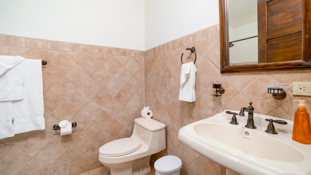A lovely bathroom with tiled walled and plenty of amenities.