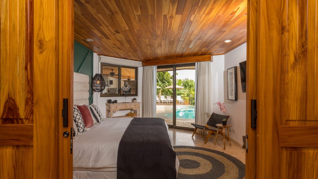This beautifully-decorated bedroom has direct access to the pool area.