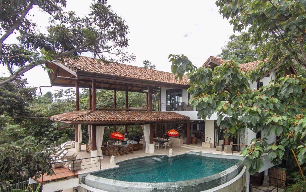 The great room and pool dominate the main level as massive tree trunk supports give the feel of being in a tree house. 