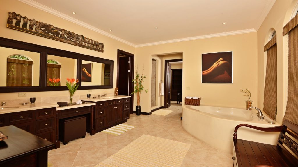 This gorgeous bathroom is beautifully designed with luxurious fixtures and wooden details.