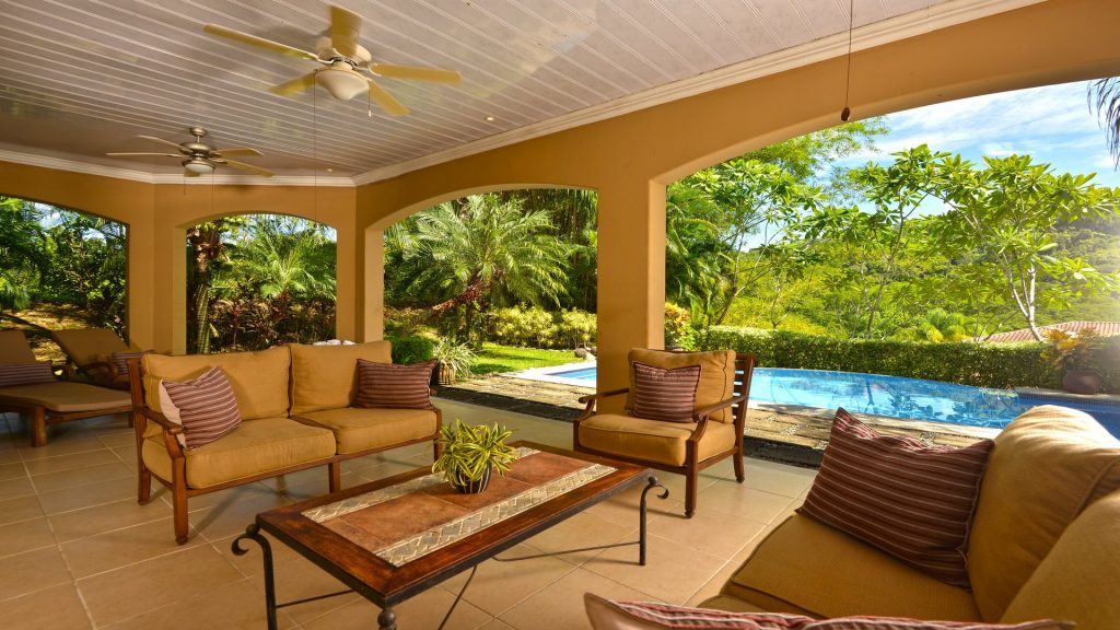 The outdoor living space next to the pool has a cool Mediterranean feel.
