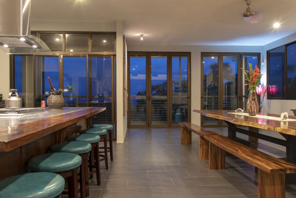 All of the glass doors open to let in the fresh ocean breeze and create an indoor-outdoor dining space.