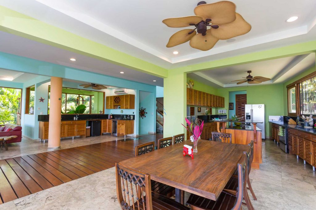 The colorful yet tasteful interior of the main level includes a dining and kitchen area, massive wet bar, and living room. 
