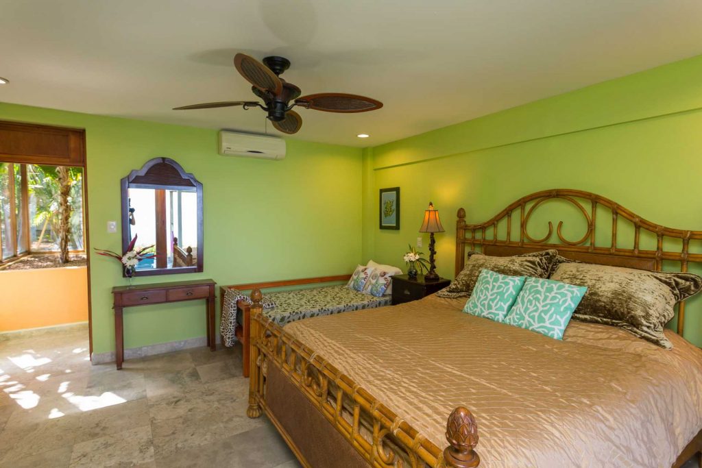 This downstairs bedroom has an ensuite bathroom and a king and twin bed. The entire villa is air conditioned. 