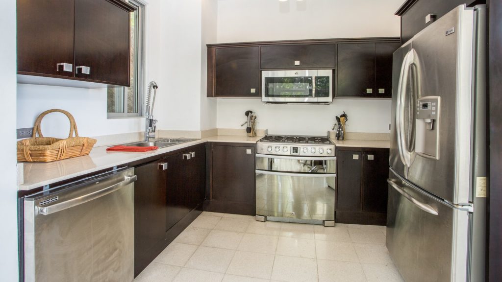 Enjoy the modern stainless-steel appliances and contrasting coffee stained cabinetry in the kitchen. 