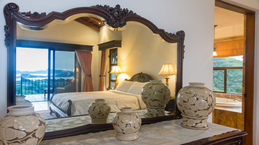 This beautifully-decorated master bedroom has an amazing ocean view from the private balcony.