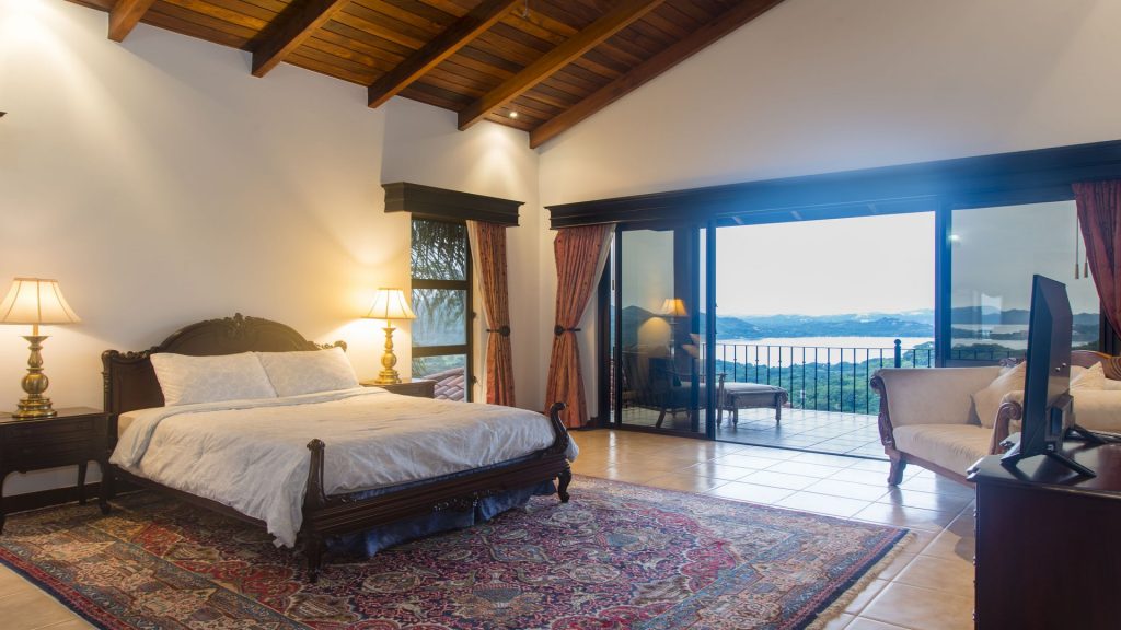The huge master bedroom has an en-suite bath, large walk-in closet, ocean view balcony and a flat-screen TV at this luxurious Playa Flamingo villa rental.