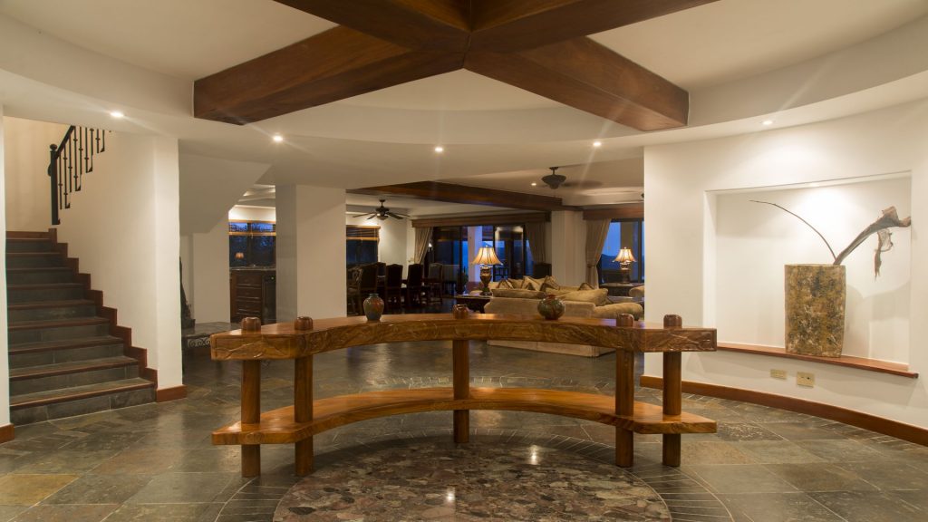 The ocean-themed hand-carved credenza in the foyer of FL-07 leads into the communal area.