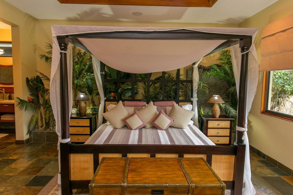 With natural stone tiles and vibrant plants adorning this bedroom, every morning you will wake up in paradise.