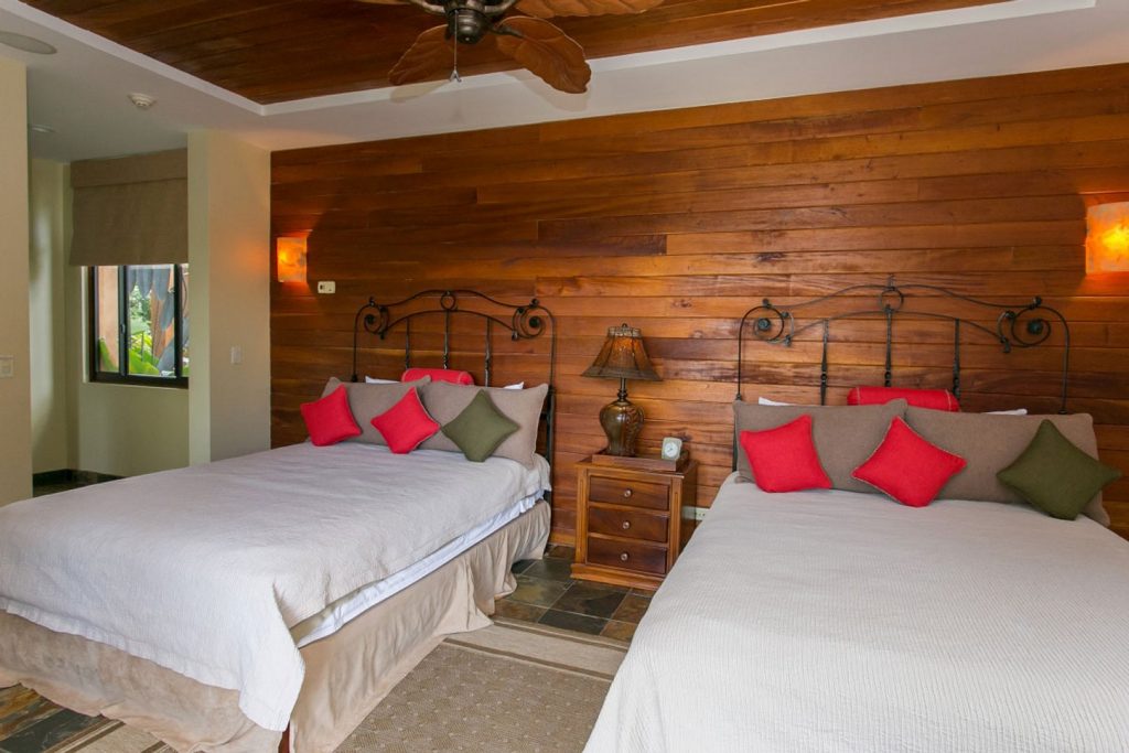 This stunning bedroom offers extra space to sleep more guests and has a tropical cabin feel.