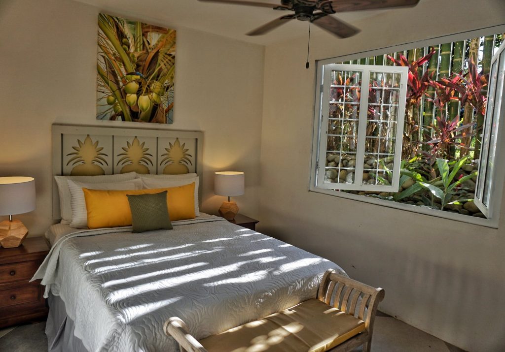This gorgeous guest room is decorated in a tropical theme. 