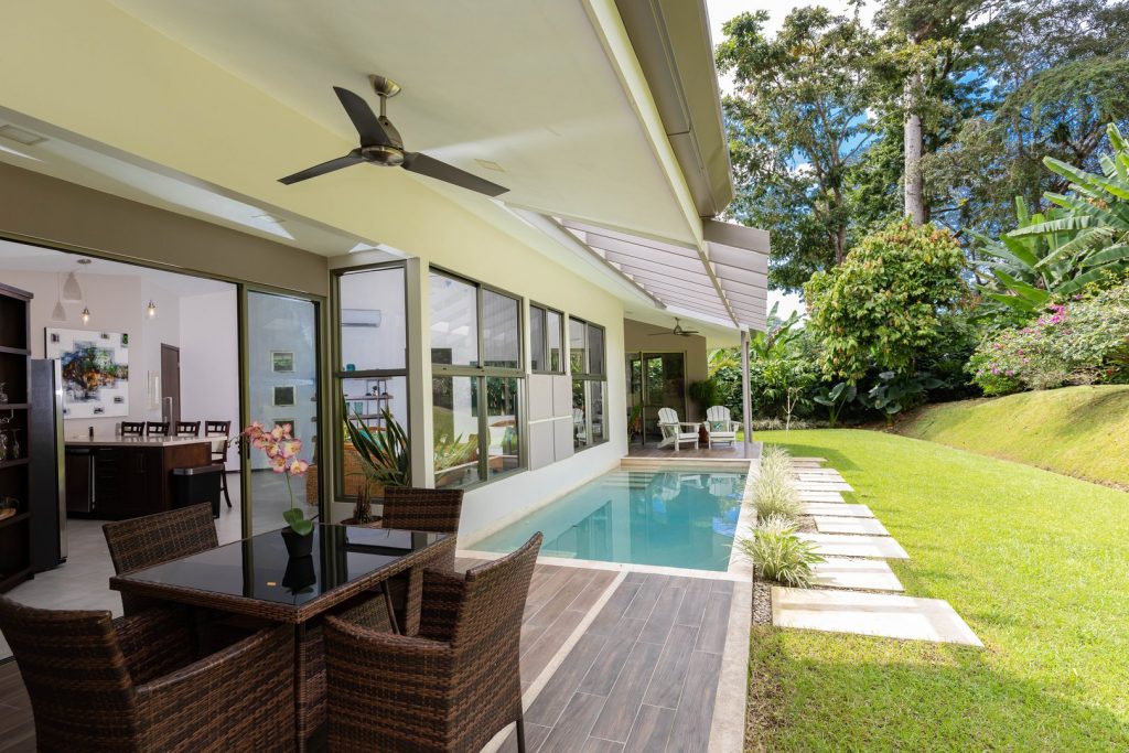 The backyard offers plenty of space to enjoy the pool with tropical gardens views.
