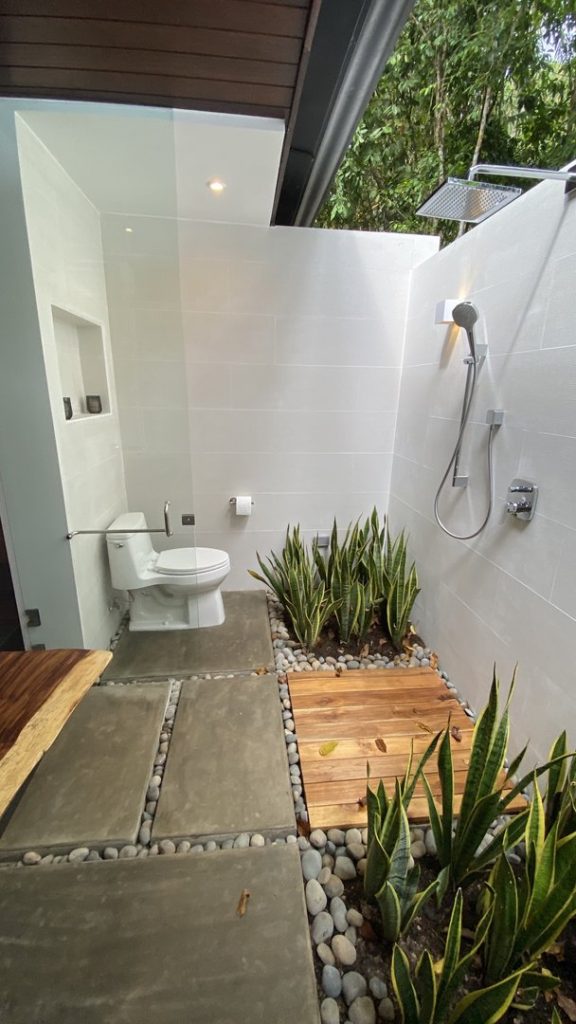 The carefully placed plants in this outside bathroom add to the natural vibe.