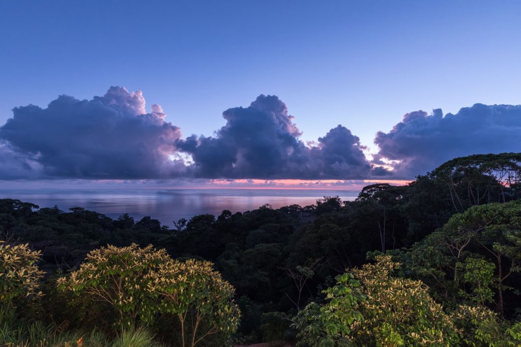 Evening views from the villa are a magical blend of tropical rainforest canopies and colourful sunsets.