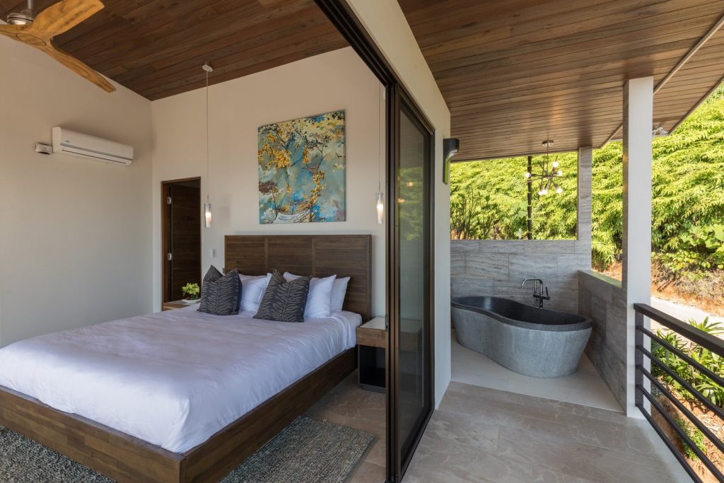 The master bedroom has air conditioning and an adjoining ensuite bathroom with a natural stone tub.