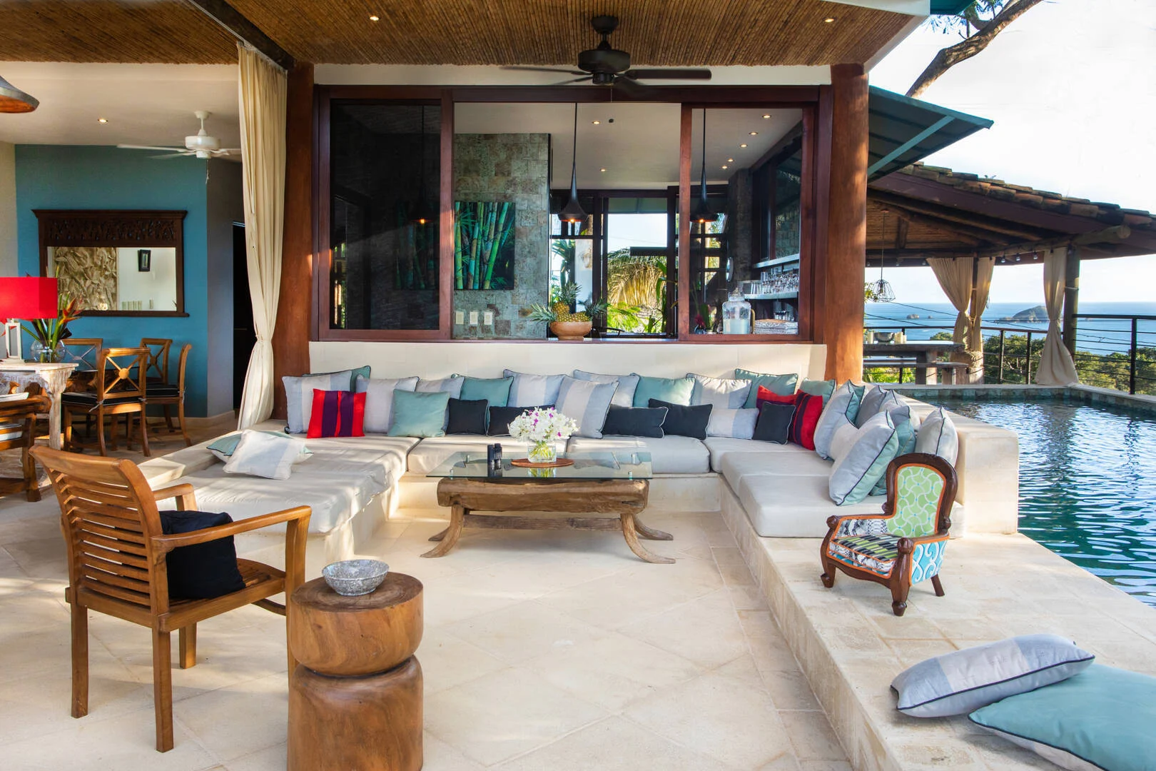 Open-air lounge with soft seating, pool access, and ocean views in Manuel Antonio