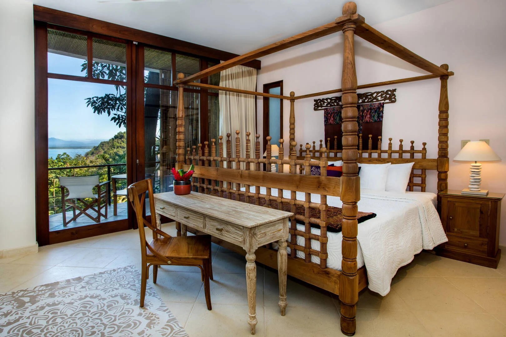 bedroom-with-wooden-canopy-bed-and-ocean-view-terrace