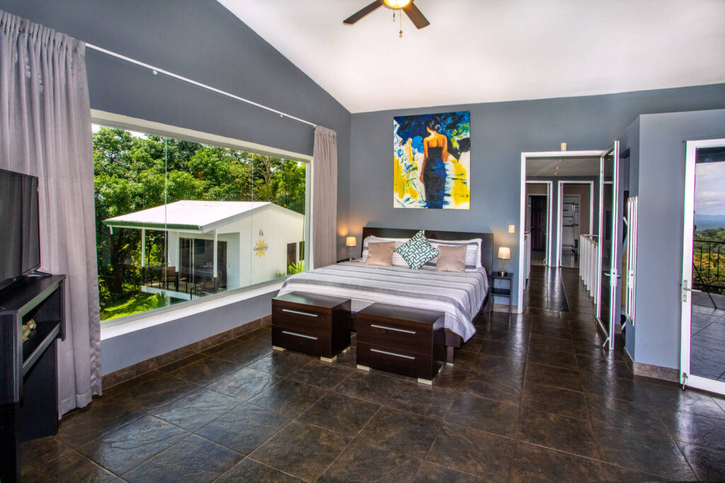 This bedroom has cool tiled floors, tasteful decor, and a breathtaking view.