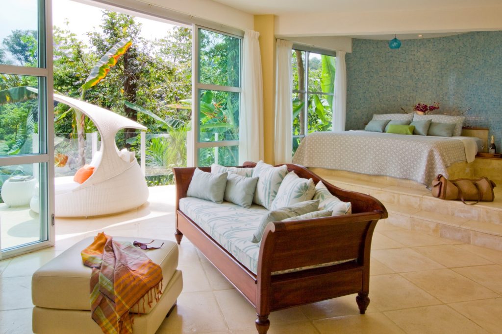 Another exquisite master bedroom with a private balcony to enjoy the sights and sounds of the tropical jungle. 