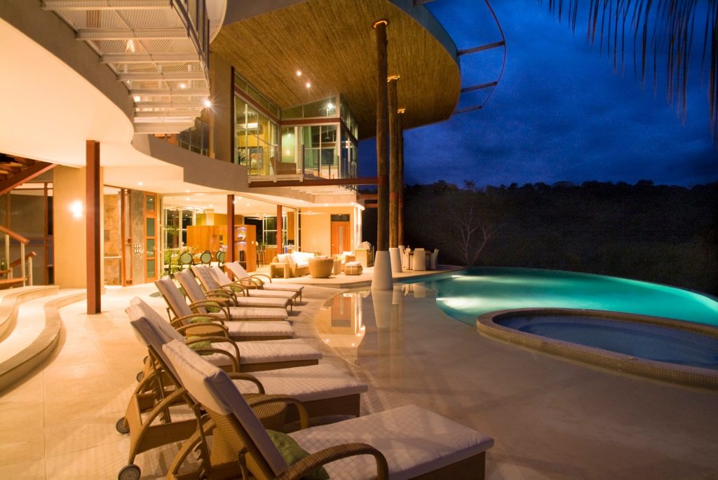 Experience the cool Costa Rican evening air from the comfort of the beautifully-lit pool and lounging area.