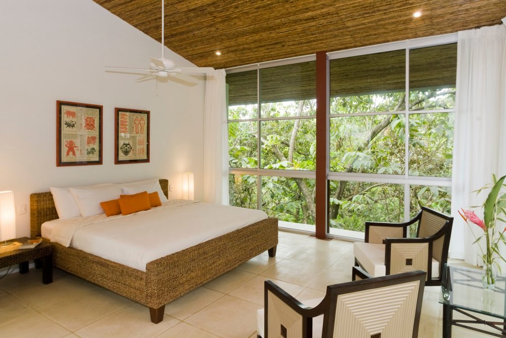 The tropical jungle is just outside this stunning bedroom full of natural features. 
