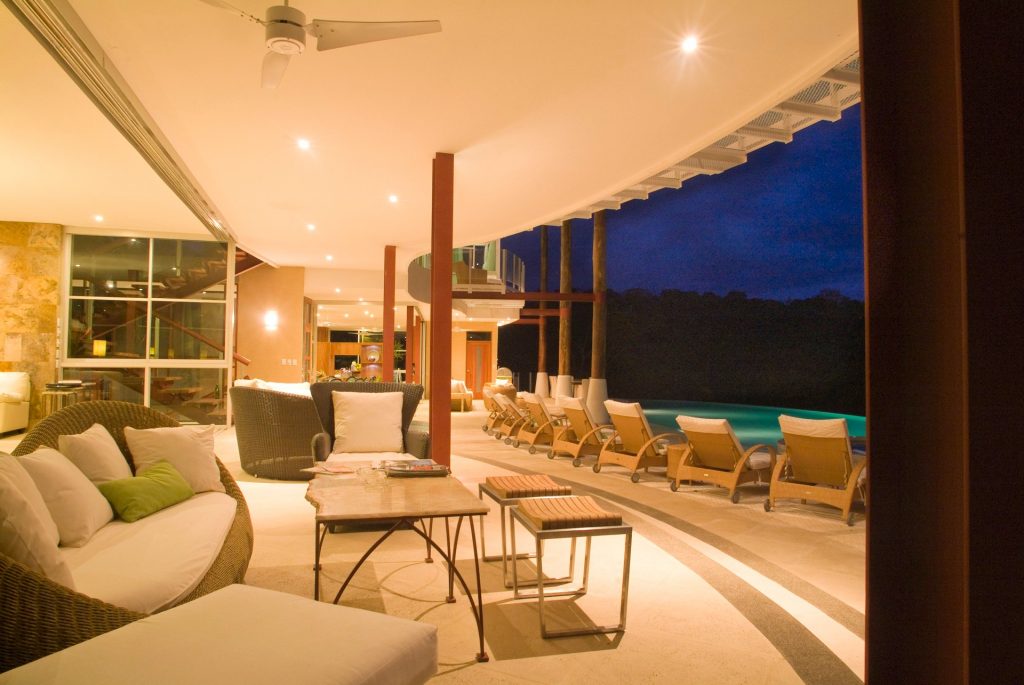 Nights are especially beautiful at this luxurious vacation villa looking out at the gorgeous pool area.
