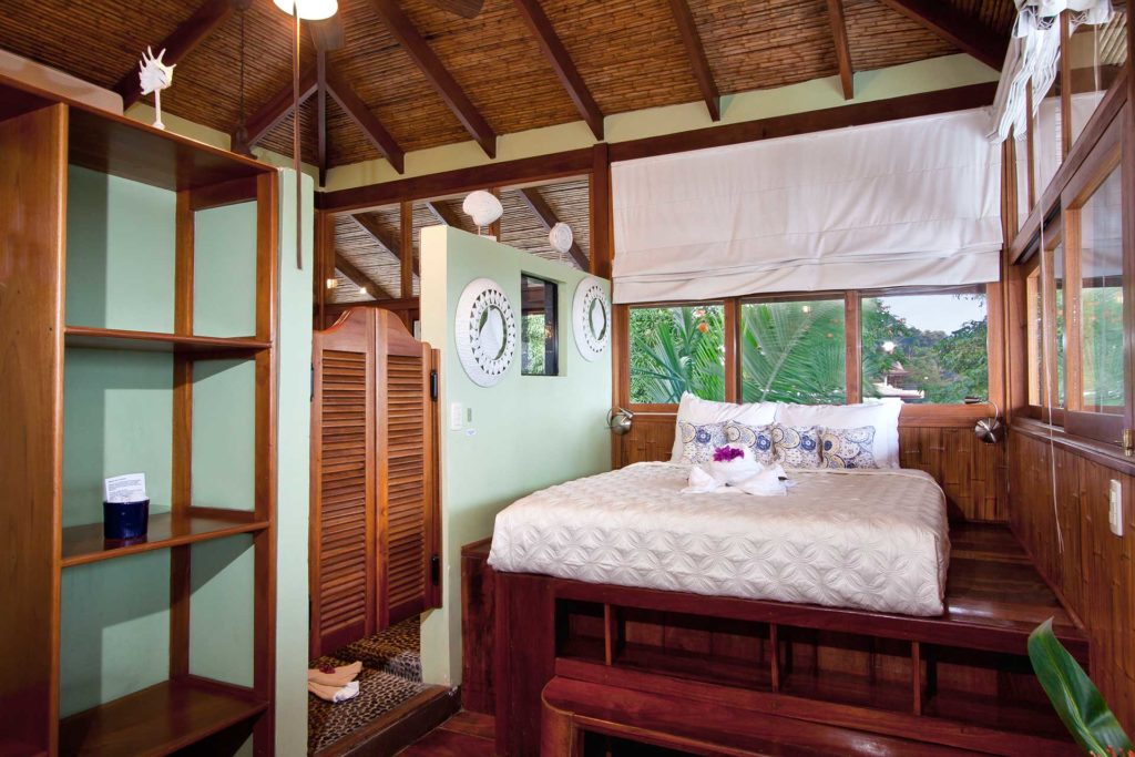 There is a luxury yet rustic feel in this bedroom at the top of the villa with vaulted bamboo ceilings.