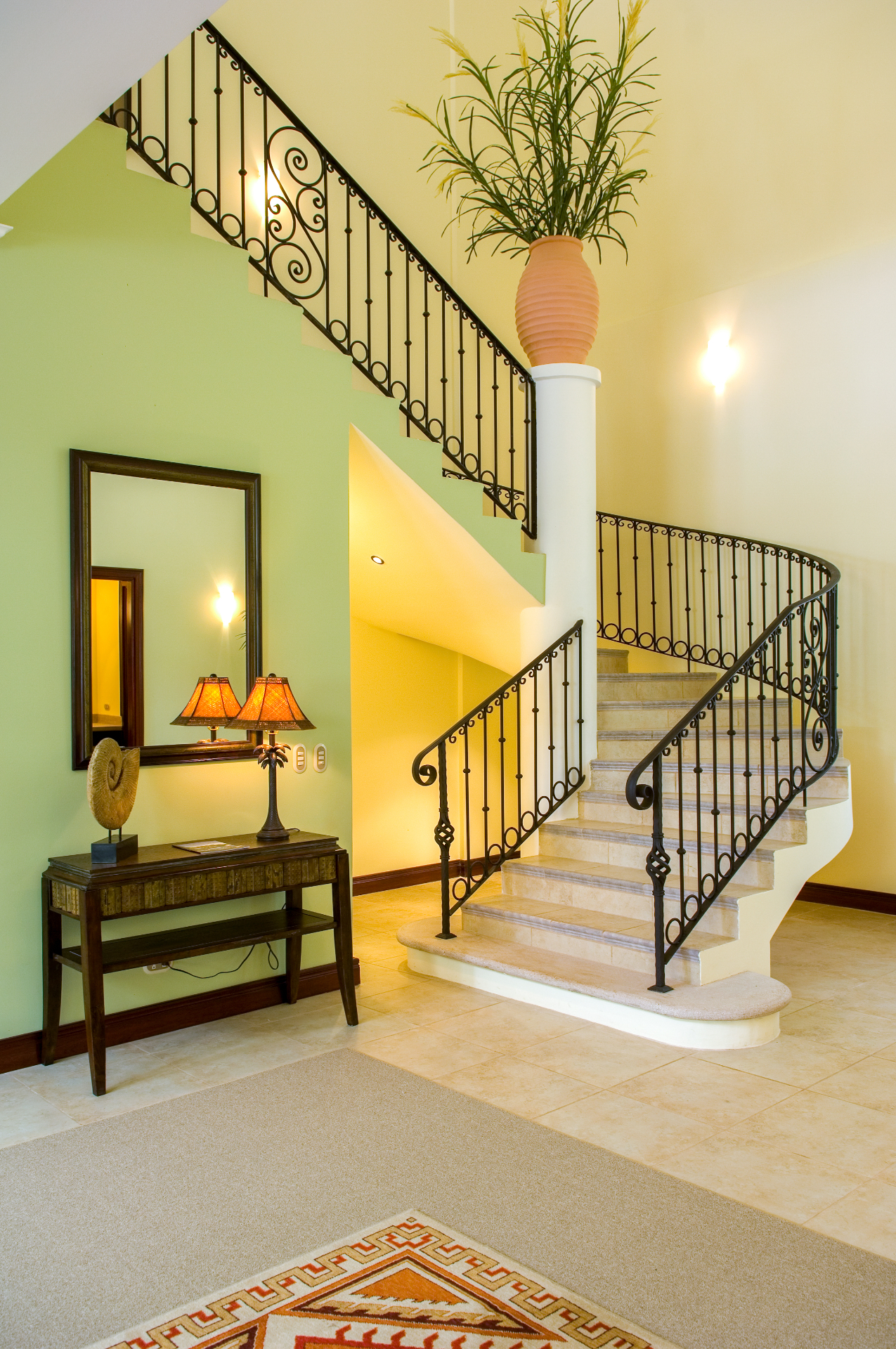 Curved interior staircase with wrought-iron railings inside the villa.