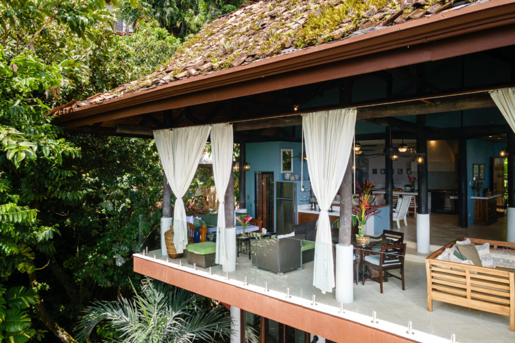 Hidden within the rainforest, this exceptional Costa Rica family vacation villa in Manuel Antonio features multiple balconies with sweeping panoramic ocean views.